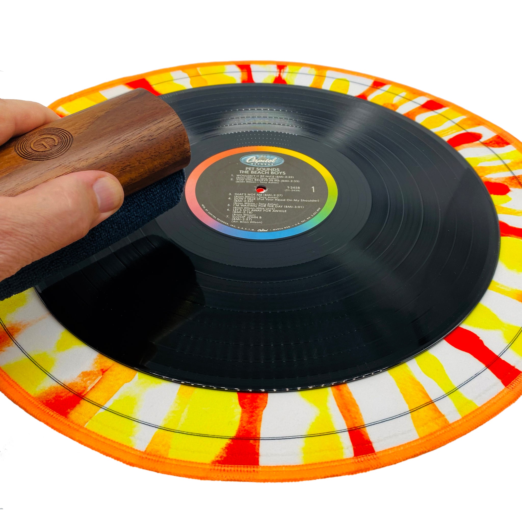 Using GrooveWasher Walnut Handle to clean a record on the 16 inch tie dye splash mat