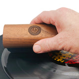 Groovewasher Walnut handle rocking across a vinyl record cleaning deep into the record grooves